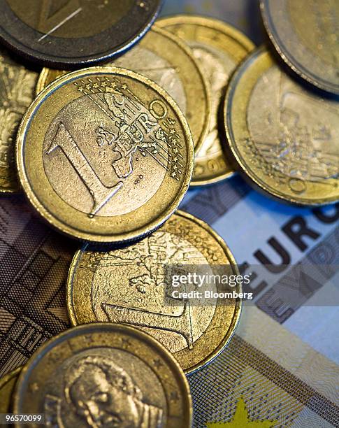 Euro notes and coins are arranged for a photograph in London, U.K., on Wednesday, Feb. 10, 2010. European Union leaders may lay the groundwork today...