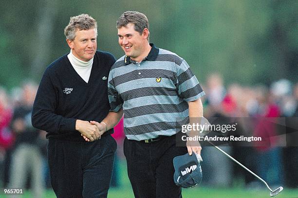 Colin Montgomerie of Scotland shakes hands with Lee Westwood of England during the Cisco World Match Play Championship at Wentworth in Surrey,...