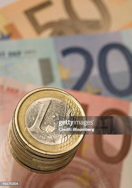 Euro notes and coins are arranged for a photograph in London, U.K., on Wednesday, Feb. 10, 2010. European Union leaders may lay the groundwork today...