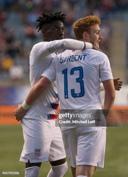 Josh Sargent of the United States hugs Tim Weah after scoring a goal during the friendly soccer match against Bolivia at Talen Energy Stadium on May...