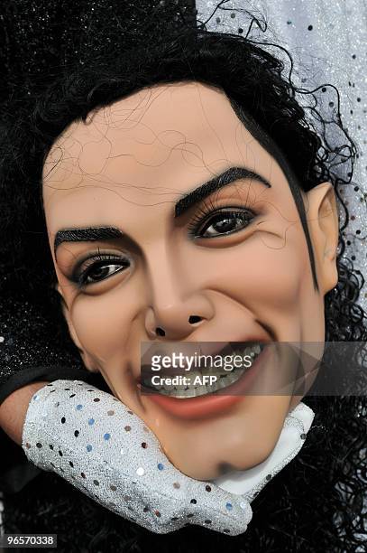 Members of the Saturno group holds a mask of late por artist Michael Jackson during a parade in Sumpango, Sacatepequez, 45 km west of Guatemala City...
