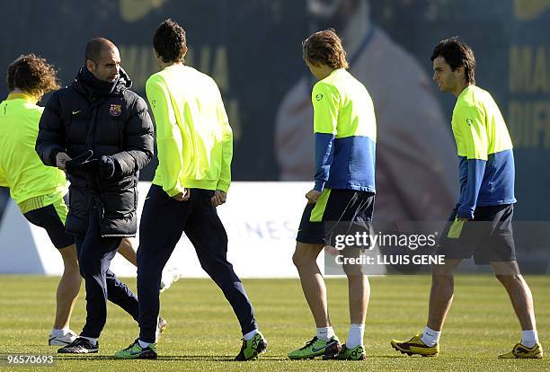 Barcelona's coach Pep Guardiola talks with Marc Bartra , Marc Muniesa and Albert Dalmau , players of Barcelona's reserve team, during a training...