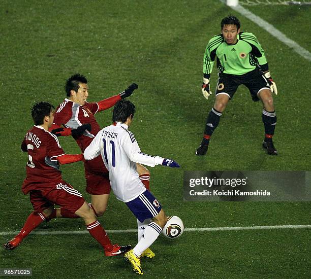 Keiji Tamada of Japan competes for the ball with Goalkeeper Hung Fai Yapp of Hong Kong during the East Asian Football Championship 2010 match between...