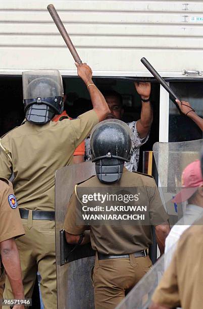 Sri Lankan policemen brandish batons as they disperse demonstrators in the eastern Colombo suburb of Maharagama on February 11, 2010. Sri Lankan...