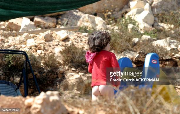 Bare-bottom young child romps care-free during the day in the West Bank settlement of Givat HaRoeh. The settlement has many young children, the...