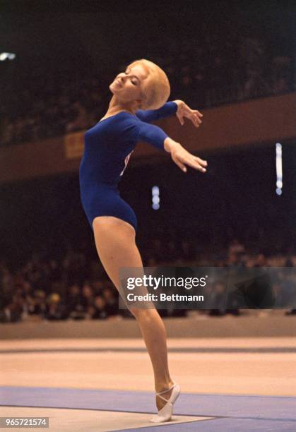 Muriel Grossfeld of U.S. Shows form in the women's gymnastics event, individual standing.