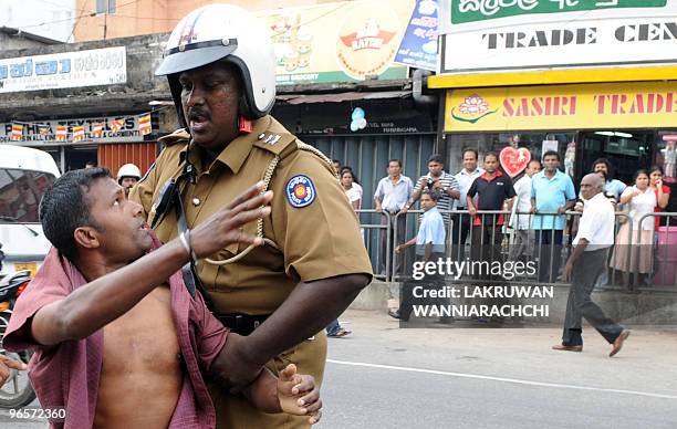 Sri Lankan policeman subdues a demonstrator in the eastern Colombo suburb of Maharagama on February 11, 2010. Sri Lankan police used batons and tear...