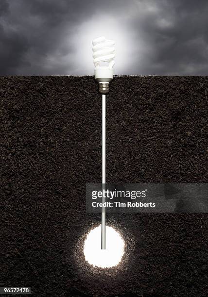 eco light bulb powered by geothermal heat. - soil cross section stock pictures, royalty-free photos & images