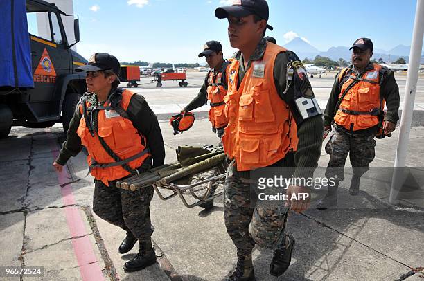 Members of the Humanitarian and Rescue Unit of the Guatemalan Army prepare to leave to Haiti, on January 13, 2010 in Guatemala City. Planeloads of...