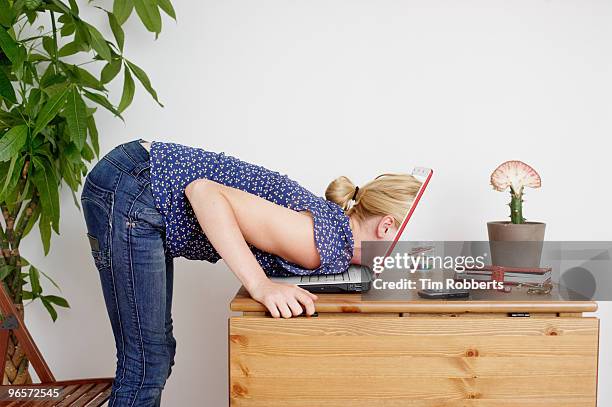 young woman peering inside laptop screen - suchen stock-fotos und bilder