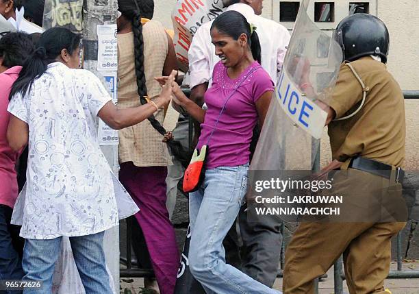 Sri Lankan riot police official baton charges an opposition demonstrator in the eastern Colombo suburb of Maharagama on February 11, 2010. Sri Lankan...