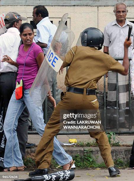 Sri Lankan riot police official baton charges an opposition demonstrator in the eastern Colombo suburb of Maharagama on February 11, 2010. Sri Lankan...