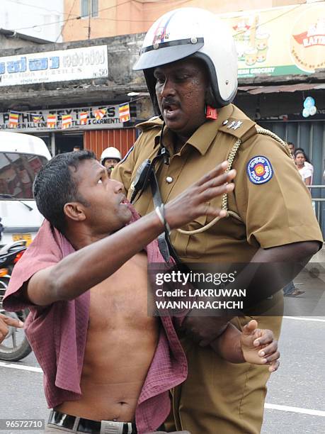Sri Lankan policeman subdues a demonstrator in the eastern Colombo suburb of Maharagama on February 11, 2010. Sri Lankan police used batons and tear...