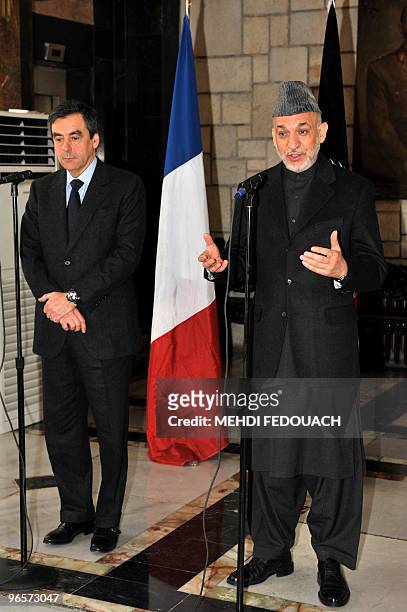 French Prime minister François Fillon listens as Afghan President Hamid Karzai addresses media representatives in Kabul on February 11, 2010. Fillon...