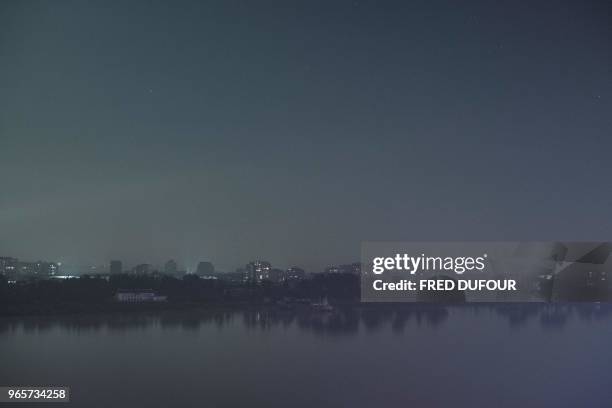 The North Korean town of Sinuiju is seen from the Chinese border town of Dandong, in China's northeast Liaoning province on May 31, 2018. - he city...