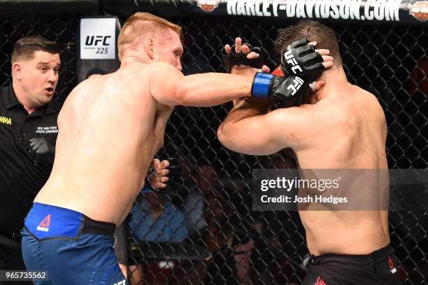 Sam Alvey punches Gian Villante in their light heavyweight fight during the UFC Fight Night event at the Adirondack Bank Center on June 1, 2018 in...