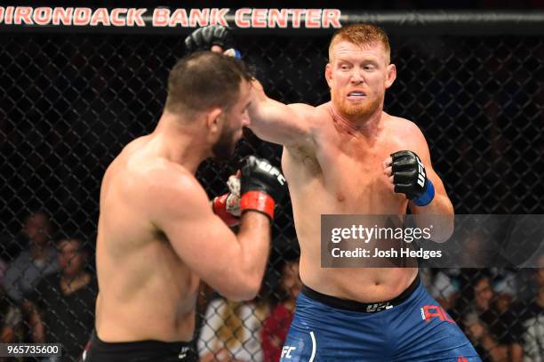 Sam Alvey punches Gian Villante in their light heavyweight fight during the UFC Fight Night event at the Adirondack Bank Center on June 1, 2018 in...