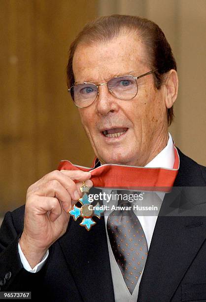 Sir Roger Moore receiving his Knighthood for charitable services at Buckingham Palace on October 8, 2003.