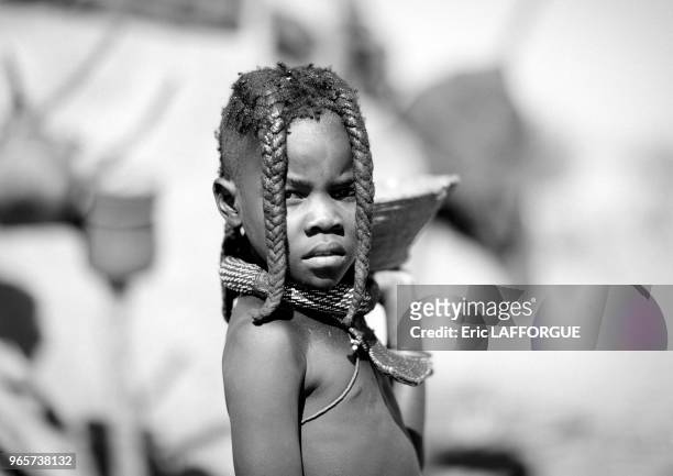 Elola village Like himba ones, pre pubescent muhimba girls wear 2 plaits in front of their faces.
