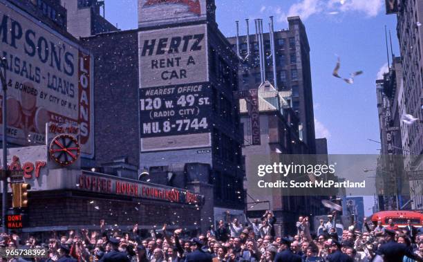 New York City - View of a crowd on 6th Avenue in midtown Manhattan for a ticker tape parade. The parade was held in honor of astronaut Gordon Cooper,...