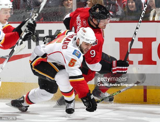 Milan Michalek of the Ottawa Senators battles for position in the corner against Mark Giordano of the Calgary Flames at Scotiabank Place on February...