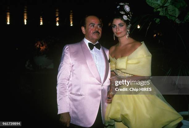 Adnan Khashoggi,a Saudi Arabian arms-dealer and businessman, celebrates his 54th birthday, here with his daughter Nabila, July 25, 1988.