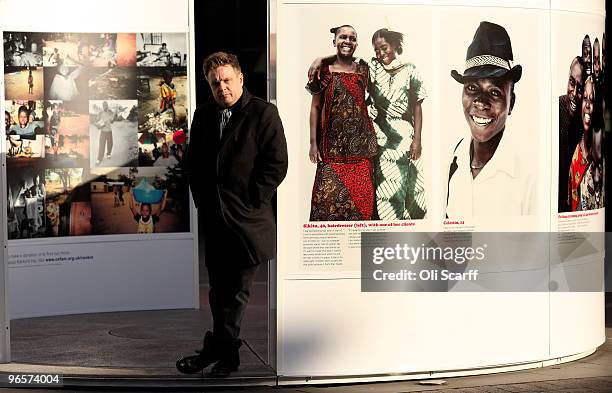 Portrait photographer Rankin poses outside the National Theatre with images he took on a recent visit to the Democratic Republic of Congo with Oxfam...