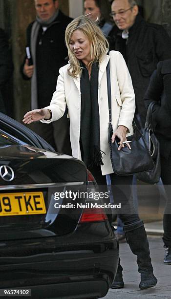 Kate Moss dashes out of Claridges Hotel into a waiting car with a cigarette in hand on February 11, 2010 in London, England.