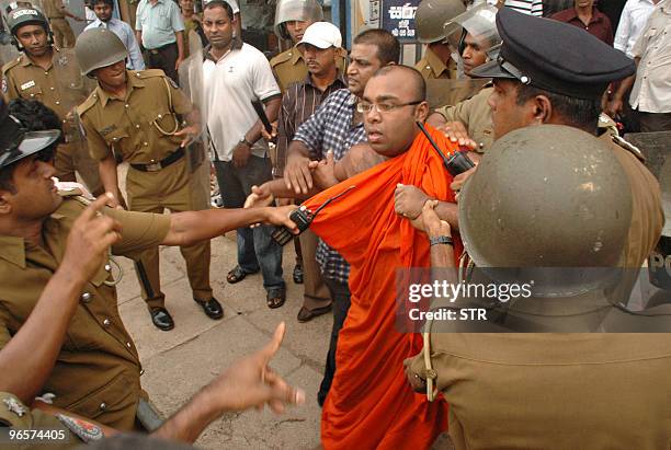 Sri Lankan monk is detained by police during a protest in the eastern Colombo suburb of Maharagama on February 11, 2010. Sri Lankan police used...