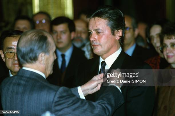 Actor Alain Delon Receives The Legion Of Honor From President Francois Mitterrand At Elysee Palace, Paris, February 21, 1991.