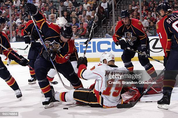 Steven Reinprecht of the Florida Panthers battles for the puck against Jamal Meyers of the Calgary Flames at the BankAtlantic Center on February 5,...