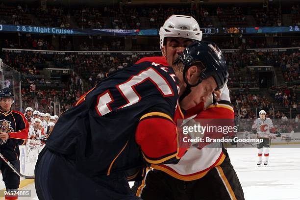 Bryan Allen of the Florida Panthers tangles with Jamal Mayers of the Calgary Flames at the BankAtlantic Center on February 5, 2010 in Sunrise,...