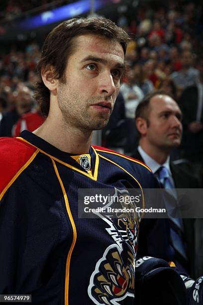 Radek Dvorak of the Florida Panthers and Head Coach Peter DeBoer stand on the bench during the National Anthem prior to the start of the game against...