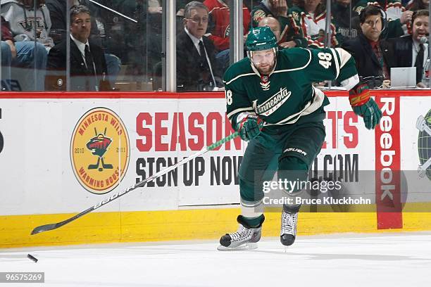 Guillaume Latendresse of the Minnesota Wild skates with the puck against the Philadelphia Flyers during the game at the Xcel Energy Center on...