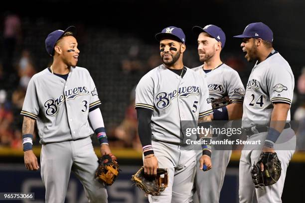 Orlando Arcia, Jonathan Villar, Travis Shaw and Jesus Aguilar of the Milwaukee Brewers talk on the field during a pitching change during the MLB game...