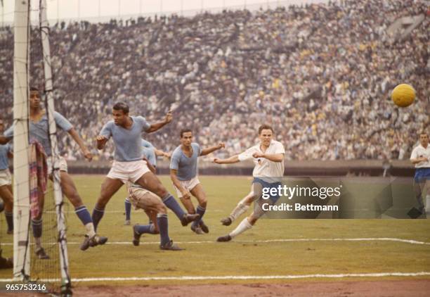 Game action during the soccer finals. Germany, in white shirts, won third place in the event and United Arab Republic, wearing blue shirts, placed...