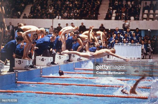Swimmers dive into the water in the Men's 4x200 Meter Relay. The U.S. Placed first in this event.