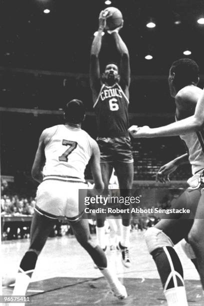 Bill Russell, center, of the visiting Boston Celtics, shoots over an unidentified Chicago Bulls player, Chicago, 1967.
