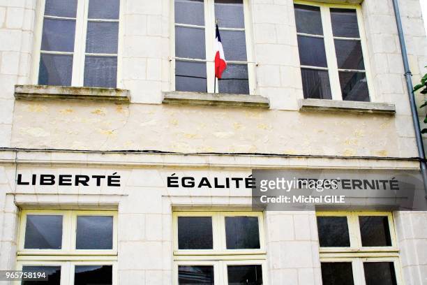 Liberté Egalité Fraternit'é et drapeau français sur la façade de la mairie, Saint-Cyr-la-Rosiere, Orne, France.