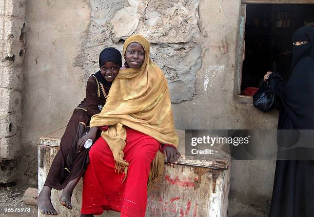 Somali refugees smile for a photo in the Basateen slum near the Yemeni southern port city of Aden on February 11, 2010. Hundreds of thousands of...