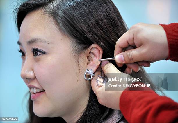 Health-medicine-tourism-SKorea,FEATURE, by Lim Chang-Won A South Korean woman receives acupuncture treatment in her ear, which doctors say is good...