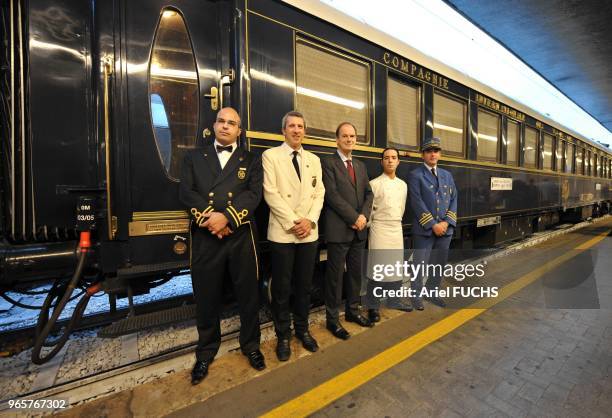 Orient Express Train arrival in Venice in Italy with the crew's farewell on the quay by train director in black suit, restaurant manager in black...