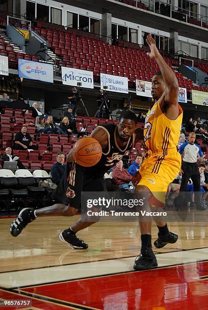 Jackie Manuel of the Erie Bayhawks moves the ball against Dar Tucker of the Los Angeles D-Fenders during the 2010 D-League Showcase at Qwest Arena on...