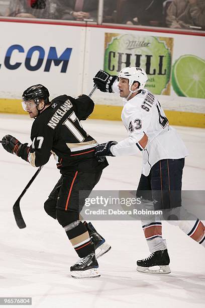 Jason Strudwick of the Edmonton Oilers defends from behind against Petteri Nokelainen of the Anaheim Ducks during the game on February 10, 2010 at...