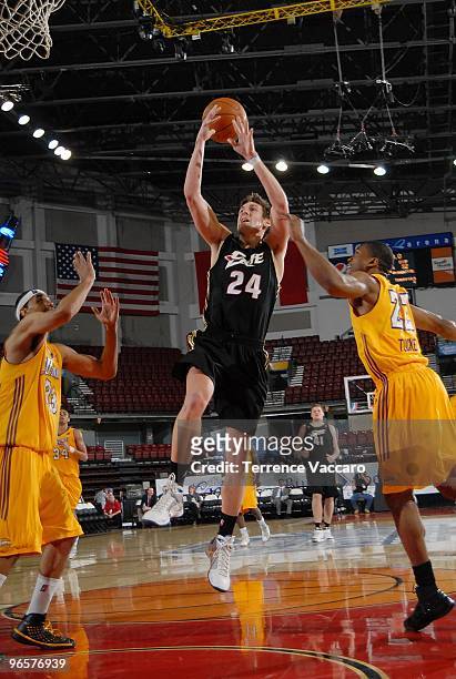 Mike Gansey of the Erie Bayhawks takes the ball to the basket against Ryan Forehan-Kelly and Dar Tucker of the Los Angeles D-Fenders during the 2010...