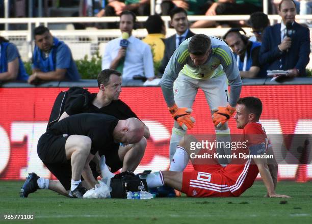 Goalkeeper Wayne Hennessey of Wales looks over at captain Aaron Ramsey after in injury against Mexico during the first half of their friendly...