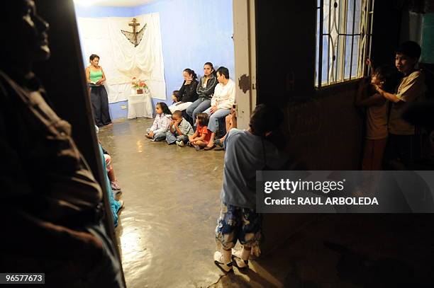 People pray for a neighbour who was killed by a stray bullet two days earlier, in Commune 1 - a shantytown with one of the highest rates of urban...