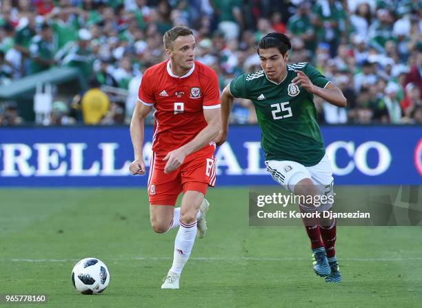 Andy King of Wales looks to pass the ball against Erick Gutierrez of Mexico during the first half of their friendly international soccer match at the...