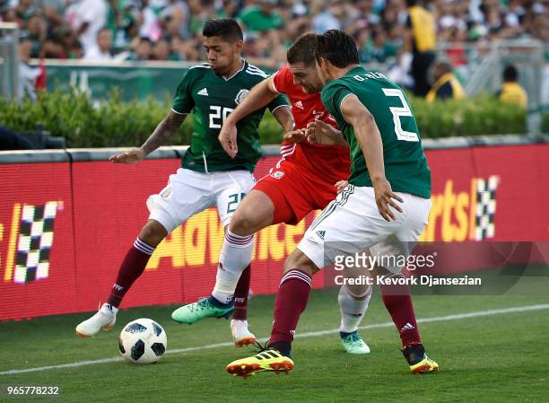 Sam Vokes of Wales is surrounded by Javier Aquino and Oswaldo Alanis of Mexico during the first half of their friendly international soccer match at...