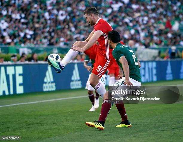 Sam Vokes of Wales controls the ball against Javier Aquino and Oswaldo Alanis of Mexico during the first half of their friendly international soccer...